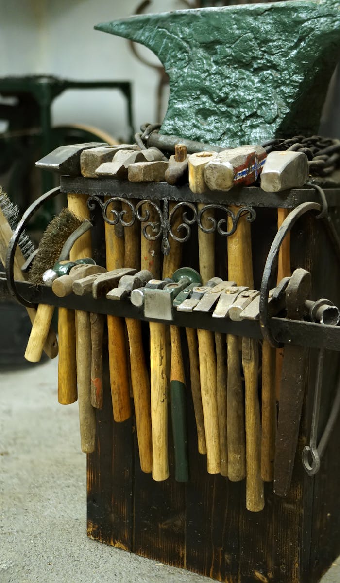 A collection of vintage hammers and tools displayed in an old workshop setting.