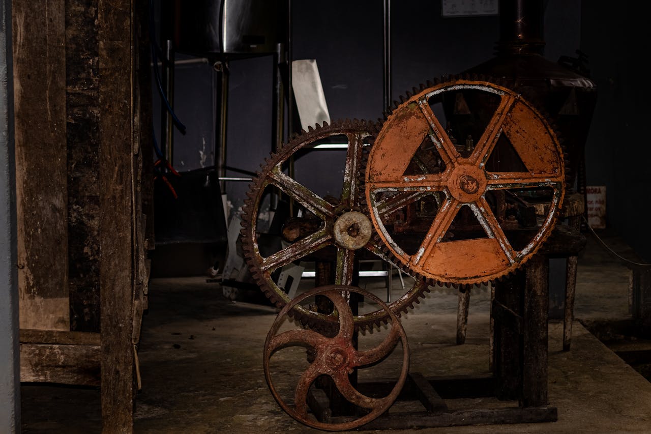 Close-up of rusty gears in an old workshop setting, showcasing industrial design.